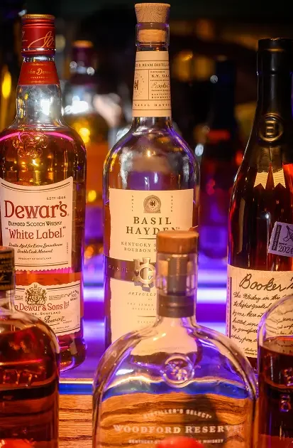Close-up of curated spirits and house-selected bottles behind the bar at Rockwell & Rose.